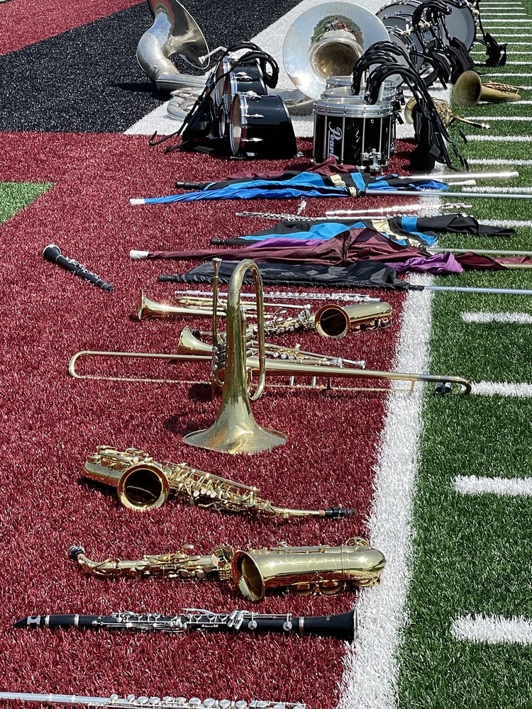 Band instruments sitting on the sideling of the football field