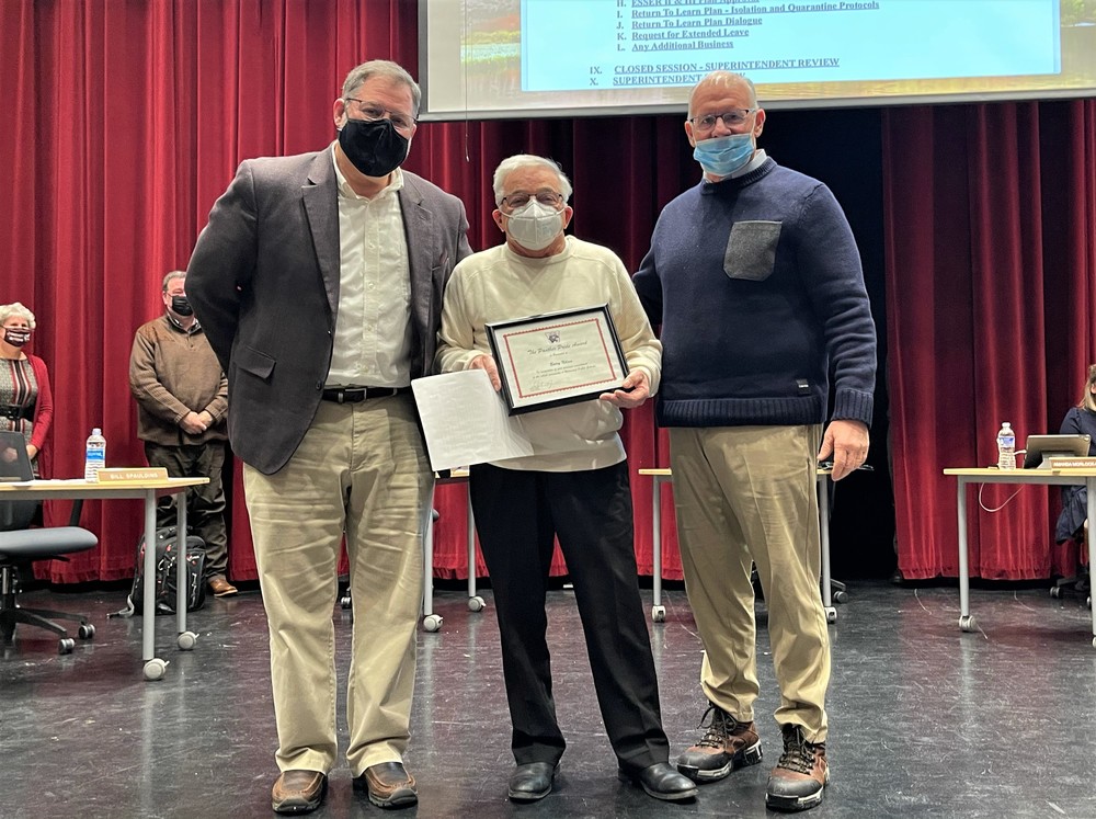 Superintendent Ric Seager, Barry Nilson, and Board of Ed President Bill Spaulding stand facing the camera.  Barry is holding the certificate he received in recognition of Panther Pride.