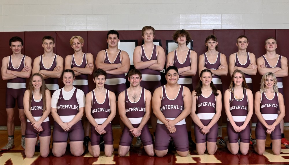 Watervliet Wrestling Team in uniform (singlets), front row of wrestlers are kneeling with hands clasped in front and back row is standing with arms  crossed.