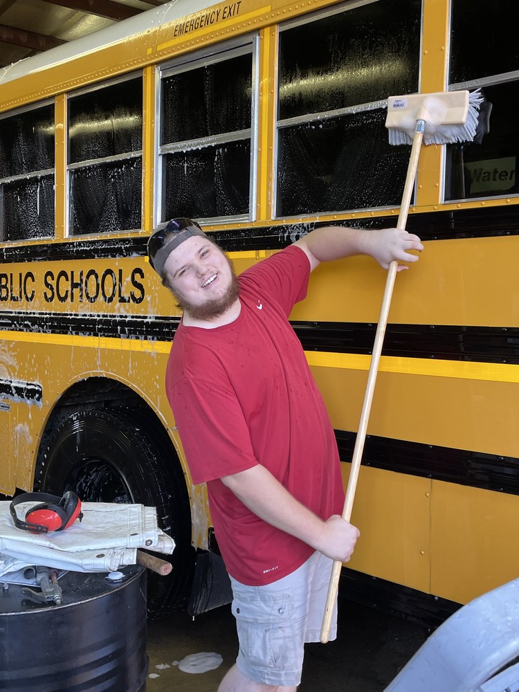 W-A-Y Watervliet High School Student Bryce Meagher washing a school bus with a brush