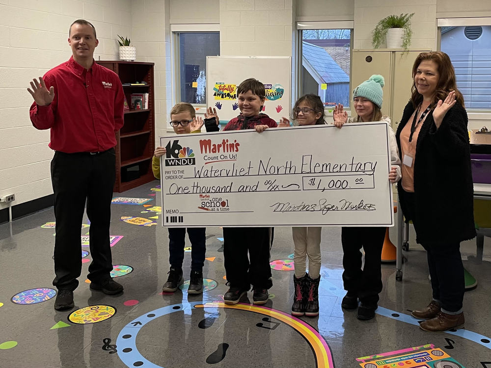 Represtatives from Martin's Supermarket and WNDU TV present an oversized check to North School students to represent a grant which the school has earned.