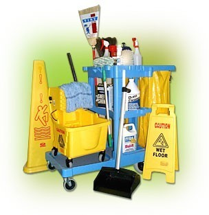 A custodian's cleaning cart loades with supplies, wet floor signs, a broom and dustpan, and mop bucket