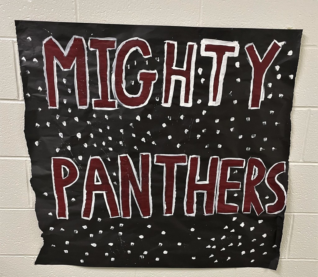 paper sign posted on the wall:  "Mighty Panthers"  in Maroon and White on black paper