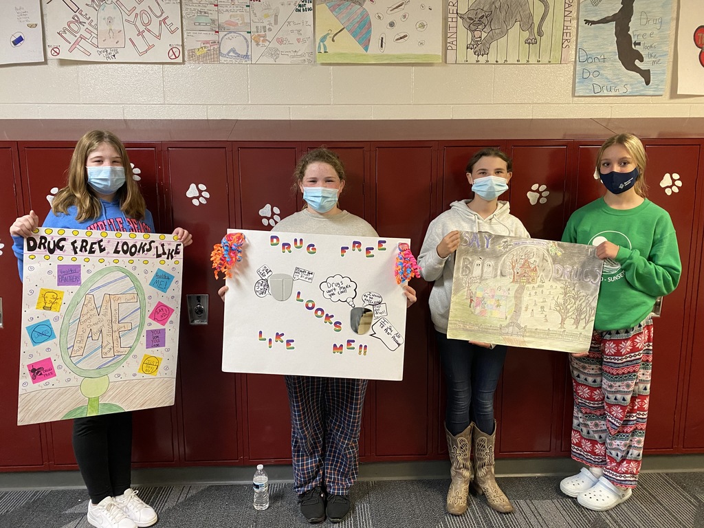 Red Ribbon Week poster contest winners holding up their posters.