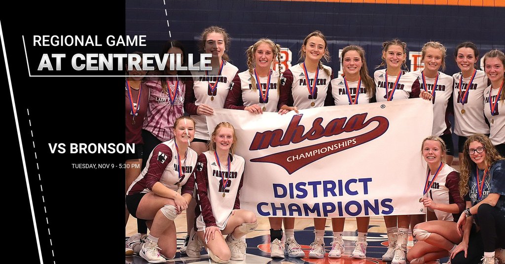 WHS varsity volleyball team holding a large sign that reads, " mhsaa Championships, District Champions". There is text that says, "Regional Game at Centreville vs. Bronson, Tuesday, Nov. 9, 5:30 PM.