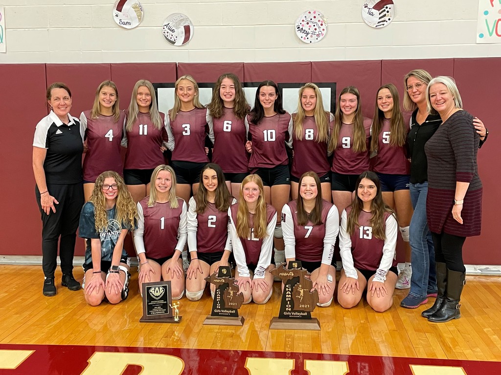 The Watervliet High School girls varsity volleyball team and coaches.  Photo is taken in the gym.  Front row is kneeling and the back row is standing.