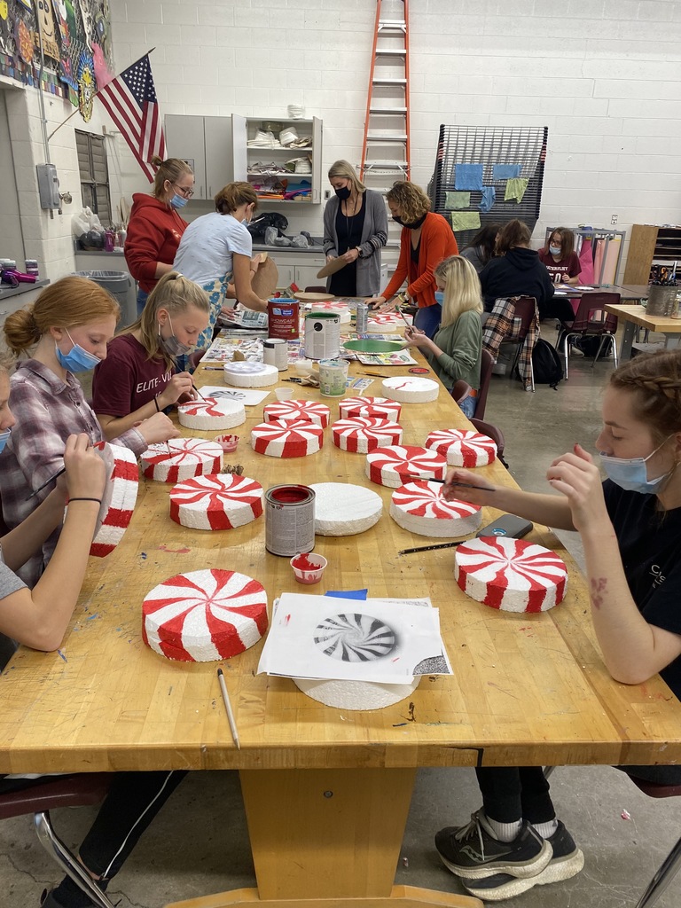 High School Students and adults are making decorations to  decorate downtown Watervliet for the Downtown Christmas Celebration.  The decorations look like large peppermint candies.