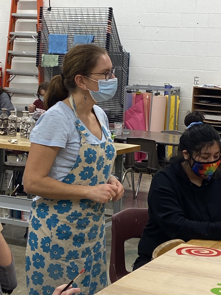 WHS art teacher Marcella Hunt (standing) oversees the making of decorations for the Watervliet Hometown Christmas Celebration.  A student is seated and working at the table next to her.
