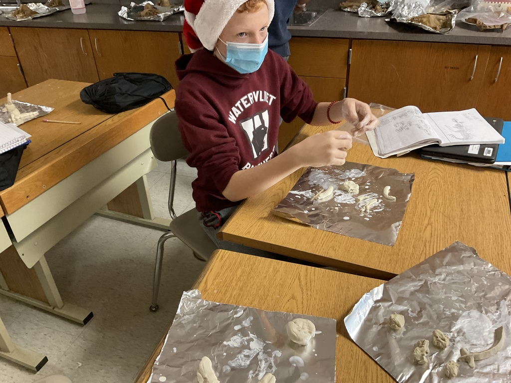 7th Grade student preparing to build clay dragon in science class.