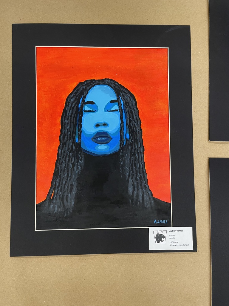 Painting of a head and shoulders of a woman done in blue and black with a  red background.  Titled:  In Blue, Acrylic, by Aubrey James, 10th grade, WHS