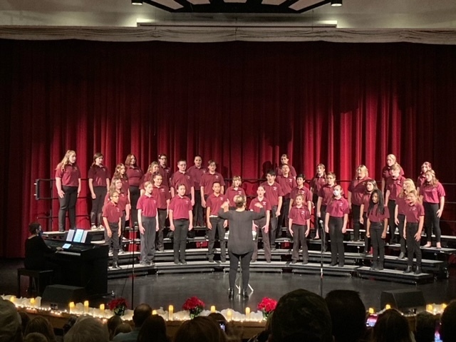 The Watervliet High School Choir Performs.  Each member wears a maroon shirt and  black pants.