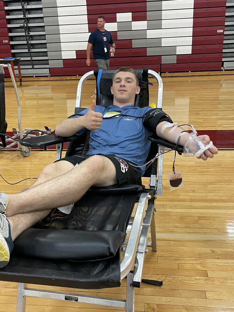 boy giving blood with thumbs up