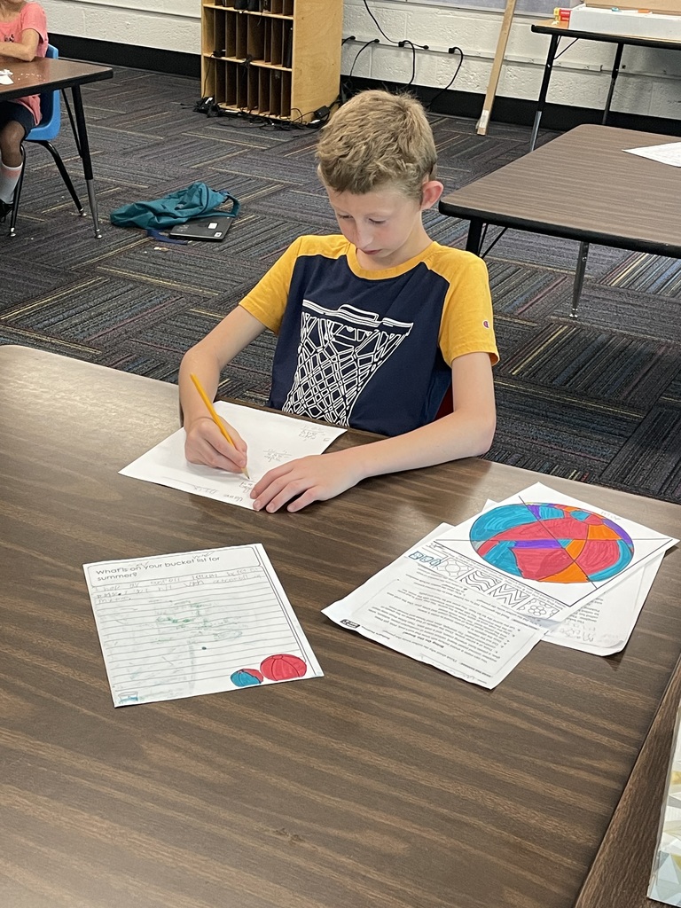 Boy working at table with drawings