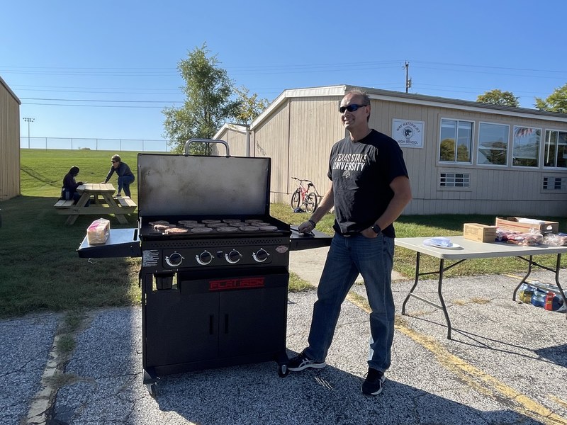 Way Director Jason Oetjens grilling up some tasty burgers for the students and bus drivers
